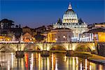 Illuminated St. Peters Basilica and the Vatican with Ponte St Angelo over the River Tiber at dusk, Rome, Lazio, Italy, Europe