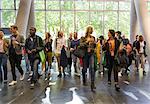 Business people arriving at conference, walking in lobby