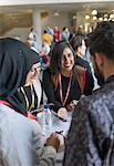 Smiling business people using smart phone at conference