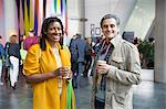 Portrait smiling, confident businessman and businesswoman drinking coffee at conference
