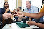 Business people networking, exchanging business cards at conference