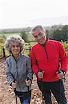 Portrait smiling, confident active senior hikers with poles