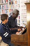 Grandfather and grandson playing piano