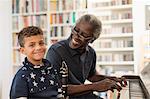 Portrait smiling, confident grandfather and grandson playing piano and clarinet