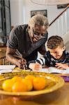 Grandfather helping grandson with geometry homework