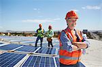 Portrait confident female engineer at sunny solar power plant