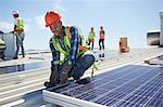 Engineer installing solar panels at sunny power plant