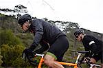 Focused, determined male cyclist cycling uphill