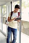 College student looking at digital tablet between classes