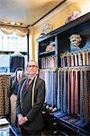 Senior tailor wearing shirt and tie in tailors shop, portrait