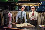 Two tailors in traditional tailors shop, portrait