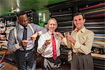 Tailors celebrating in traditional tailors shop, portrait