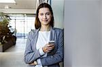 Businesswoman using mobile phone in office