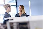 Businesswomen chatting in office