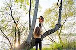 Fashion blogger twins on tree, Mantova, Lombardia, Italy