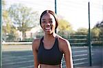 Young woman smiling in sports court