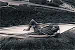 Young male climber reclining in hammock on bellygood ledge, The Chief, Squamish, Canada, B&W overhead view