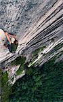 Young man climbing up rock face, 'the grand wall', The Chief, Squamish, Canada, high angle view