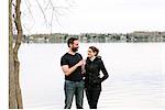 Couple relaxing by lake, Kingston, Canada