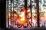 Part unloaded touring motorcycle parked on forest roadside at sunset, Yosemite National Park, California, USA
