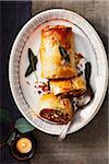 Vegetable strudel on a platter with candle