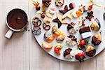 Cookies and sweets dipped in melted chocolate on a platter