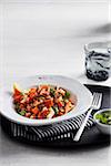 Lentil and sweet potato salad with fresh cilantro in bowl with fork