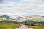 Landscape with rural road through mountain valley, Browning, Montana, USA