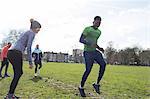 Man doing speed ladder dill in sunny park