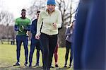 Determined senior woman exercising in park