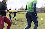 People doing team building exercise in sunny park