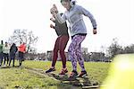 Women exercising, doing ladder drill in sunny park