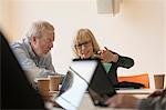 Senior business people using laptop in conference room meeting