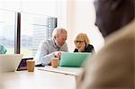 Senior business people using laptop in conference room meeting