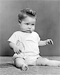 1940s BABY SITTING CHIN DOWN FROWNING