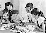 1950s FAMILY OF FIVE READING MAGAZINES BOOKS ON DINING ROOM TABLE