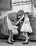 1960s WOMAN MOTHER IN KITCHEN DISCIPLINING GIRL HER DAUGHTER