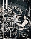 1930s ANONYMOUS MAN SEATED AT COMPOSING KEYBOARD OF LINOTYPE HOT METAL TYPESETTING MACHINE