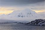 Misty Mount William at sunrise, rising from tidewater glaciers, Anvers Island, Antarctic Peninsula, Antarctica, Polar Regions