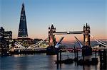 Tower Bridge illuminated at night, with the bridge raised over the River Thames, London, England, United Kingdom, Europe