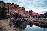 A river running through a valley with large rock formations on either side, Oregon, United States of America, North America