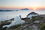 White Greek church and Milos Bay from Plaka Castle at sunset, Plaka, Milos, Cyclades, Aegean Sea, Greek Islands, Greece, Europe