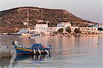 Fishing boat in harbour with town behind, Pollonia, Milos, Cyclades, Aegean Sea, Greek Islands, Greece, Europe