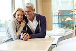 Couple using smart phone in café