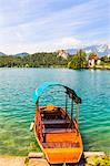 A boat on Lake Bled with Bled Castle in the background, Lake Bled, Slovenia, Europe