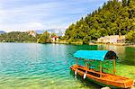 A boat on Lake Bled with Bled Castle in the background, Lake Bled, Slovenia, Europe