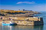 Craster Harbour and Dunstanburgh Castle, Northumberland, England, United Kingdom, Europe