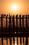 Sunset at U Bein bridge, oldest and longest teak bridge in the world, across Lake Taungthaman, Amarapura, Myanmar (Burma), Asia