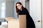 Woman with cardboard boxes packaging