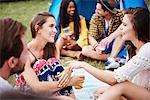 Friends sitting and enjoying music festival